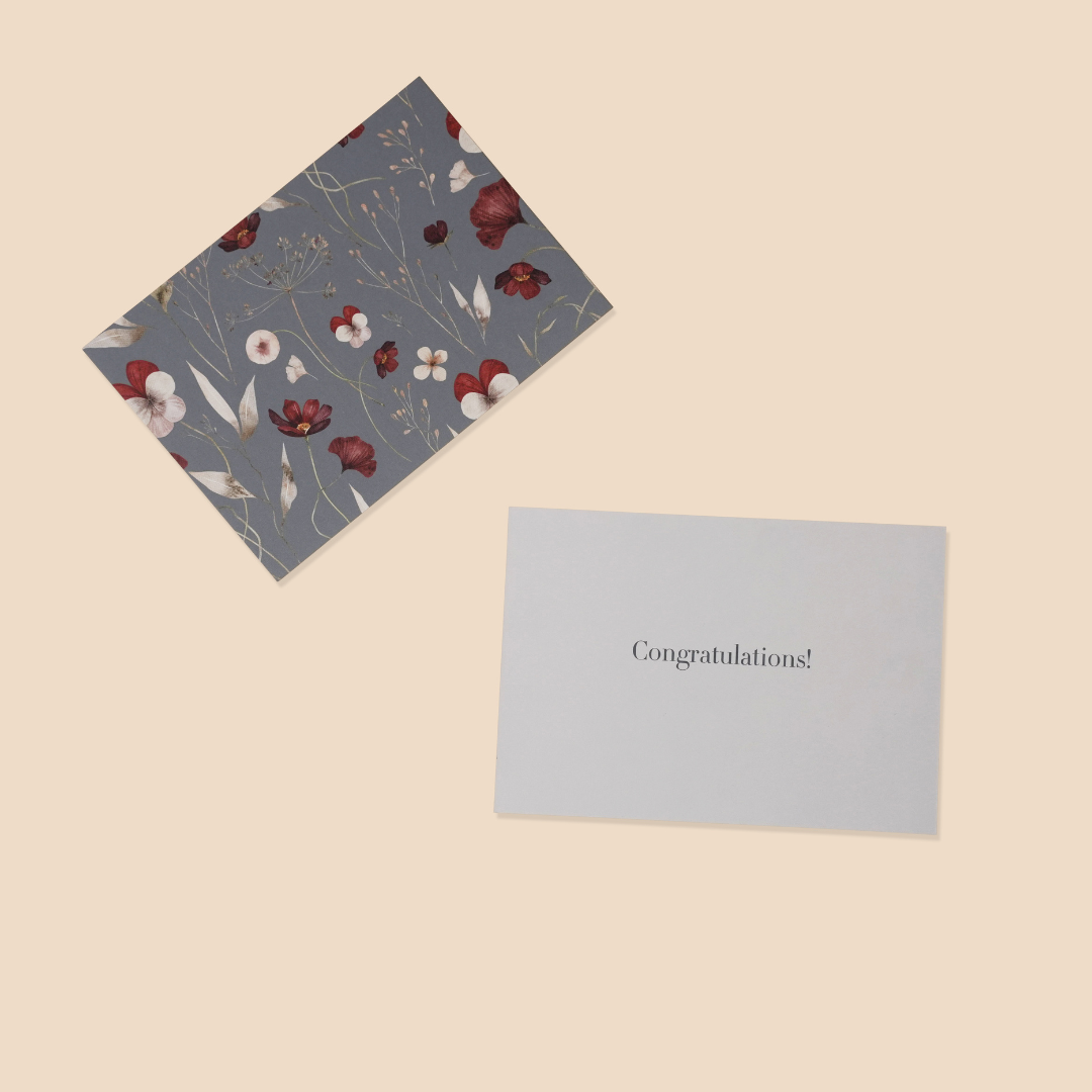 Floral-patterned card and a plain card with 'Congratulations!' text on a beige background