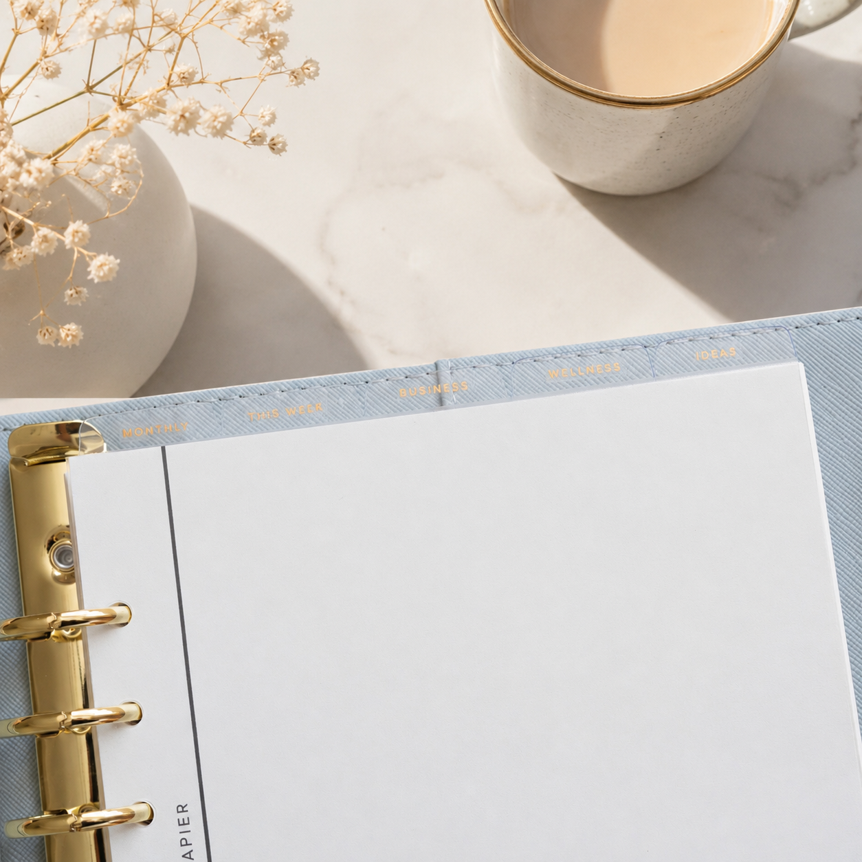 Planner with gold binding on a top divider tabs
